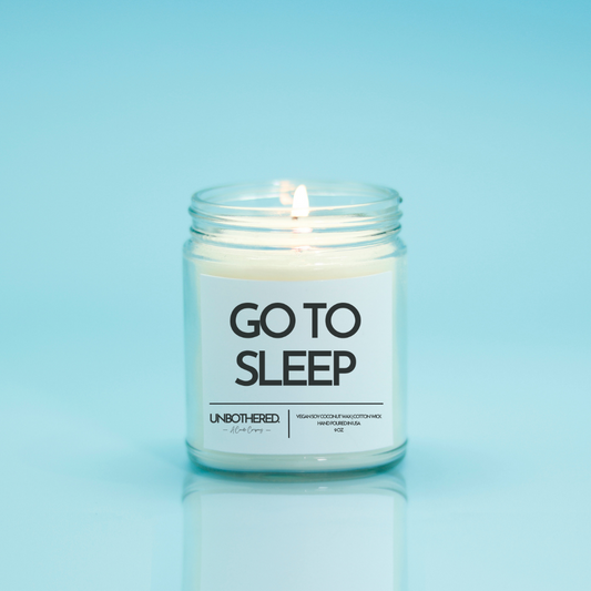 Go To Sleep Candle from the Unbothered Candle Co. Available in two Limited Edition Scents Pine Tree*, Holly Berry*, and two signature scents Cinnamon Roll and Vanilla Cookie. Vegan Soy Coconut Wax, 100% Cotton Wick, Hand-poured in the USA, Eco-friendly, non-toxic, no lead, no parabens, no synthetic dyes, no phthalates, and NEVER tested on animals.