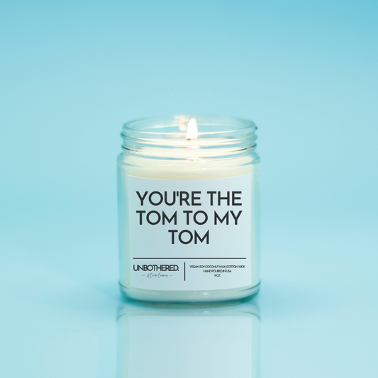 You're the Tom to my Tom Candle from The Unbothered Candle Co. Available in two Limited Edition Scents Pine Tree*, Holly Berry*, and two signature scents Cinnamon Roll and Vanilla Cookie. Vegan Soy Coconut Wax, 100% Cotton Wick, Hand-poured in the USA, Eco-friendly, non-toxic, no lead, no parabens, no synthetic dyes, no phthalates, and NEVER tested on animals.