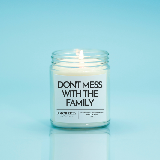 Don't Mess With The Family Candle from the Unbothered Candle Co. Available in two Limited Edition Scents Pine Tree*, Holly Berry*, and two signature scents Cinnamon Roll and Vanilla Cookie. Vegan Soy Coconut Wax, 100% Cotton Wick, Hand-poured in the USA, Eco-friendly, non-toxic, no lead, no parabens, no synthetic dyes, no phthalates, and NEVER tested on animals.