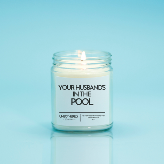 Your Husband's in the Pool Candle from the Unbothered Candle Co. Available in two Limited Edition Scents Pine Tree*, Holly Berry*, and two signature scents Cinnamon Roll and Vanilla Cookie. Vegan Soy Coconut Wax, 100% Cotton Wick, Hand-poured in the USA, Eco-friendly, non-toxic, no lead, no parabens, no synthetic dyes, no phthalates, and NEVER tested on animals.