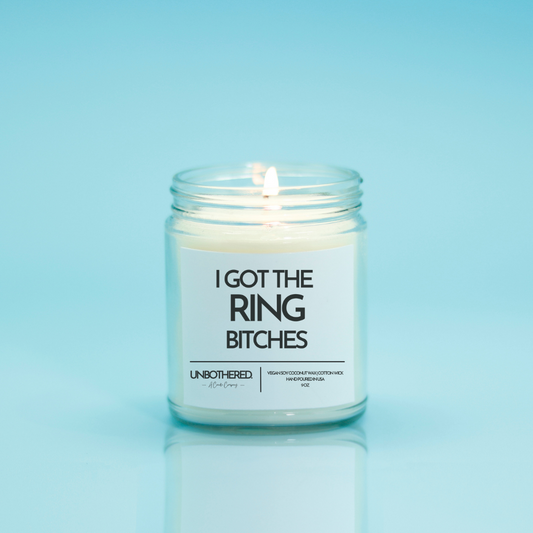 I Got The Ring Bitches Candle from the Unbothered Candle Co. Available in two Limited Edition Scents Pine Tree*, Holly Berry*, and two signature scents Cinnamon Roll and Vanilla Cookie. Vegan Soy Coconut Wax, 100% Cotton Wick, Hand-poured in the USA, Eco-friendly, non-toxic, no lead, no parabens, no synthetic dyes, no phthalates, and NEVER tested on animals.