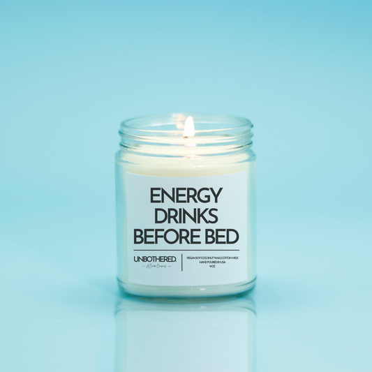 Energy Drinks Before Bed Candle from the Unbothered Candle Co. Available in two Limited Edition Scents Pine Tree*, Holly Berry*, and two signature scents Cinnamon Roll and Vanilla Cookie. Vegan Soy Coconut Wax, 100% Cotton Wick, Hand-poured in the USA, Eco-friendly, non-toxic, no lead, no parabens, no synthetic dyes, no phthalates, and NEVER tested on animals.