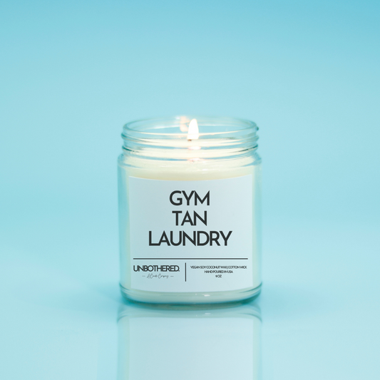 Gym Tan Laundry Candle from the Unbothered Candle Co. Available in two Limited Edition Scents Pine Tree*, Holly Berry*, and two signature scents Cinnamon Roll and Vanilla Cookie. Vegan Soy Coconut Wax, 100% Cotton Wick, Hand-poured in the USA, Eco-friendly, non-toxic, no lead, no parabens, no synthetic dyes, no phthalates, and NEVER tested on animals.
