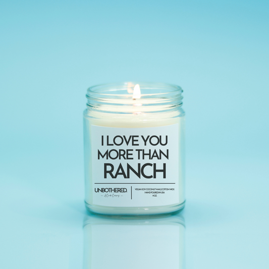 I Love You More Than Ranch Candle from the Unbothered Candle Co. Available in two Limited Edition Scents Pine Tree*, Holly Berry*, and two signature scents Cinnamon Roll and Vanilla Cookie. Vegan Soy Coconut Wax, 100% Cotton Wick, Hand-poured in the USA, Eco-friendly, non-toxic, no lead, no parabens, no synthetic dyes, no phthalates, and NEVER tested on animals.